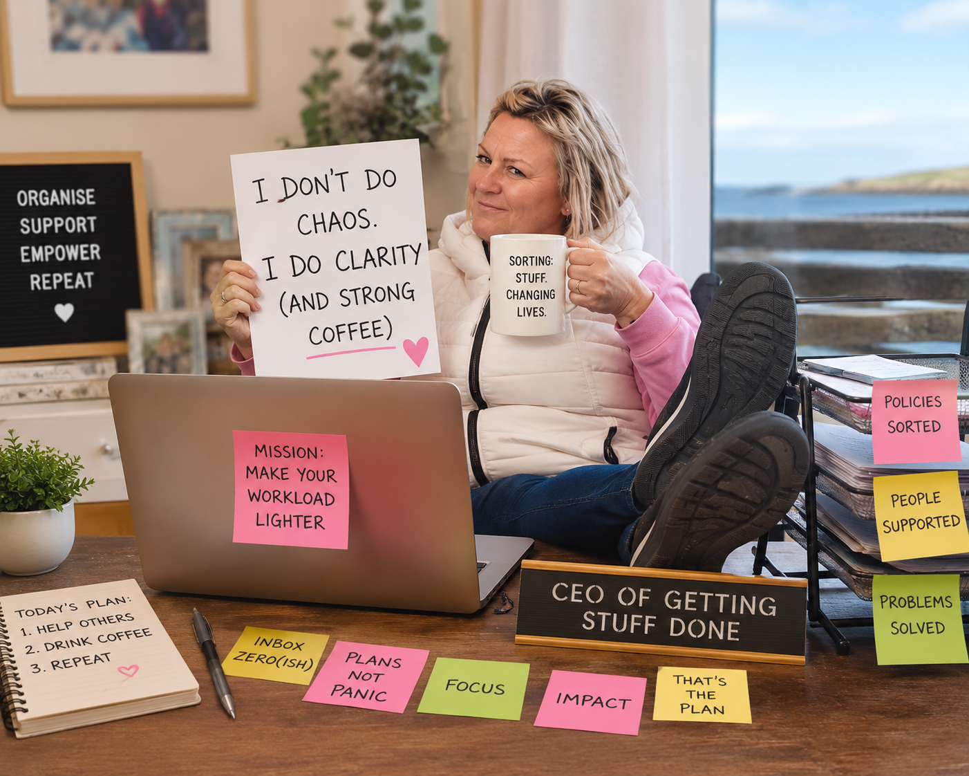 woman holding sign "I don't do chaos, I do clarity (and strong coffee)" at a desk with CEO of Getting Stuff Done sign on it.